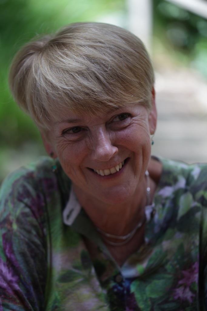 Photograph of Alison Frater, Chair of Clean Break Theatre Company. Smiling white woman with short blonde hair and a green floral top.
